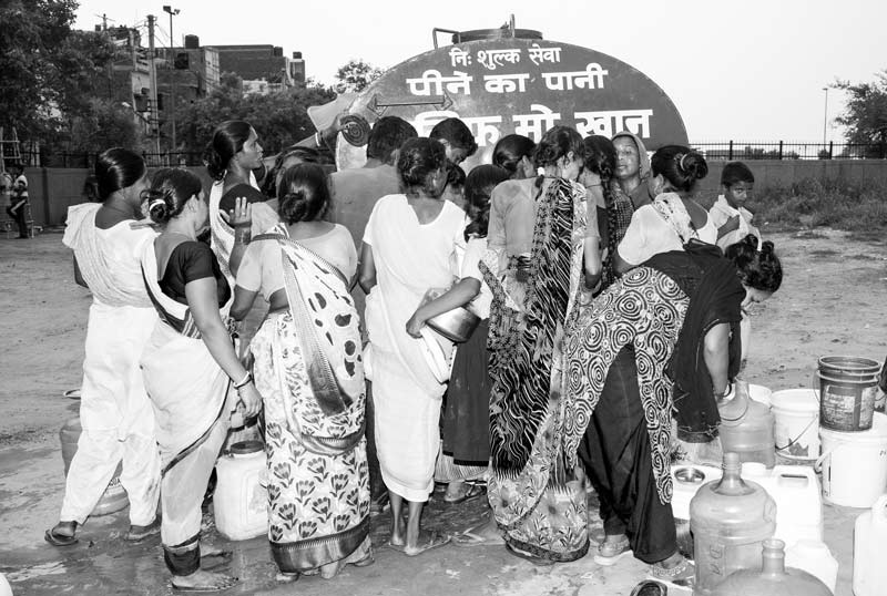 Women and Drinking Water Challenges - Women struggling for procuring a container of drinking water from a tanker in South-East district, National Capital Territory of Delhi
